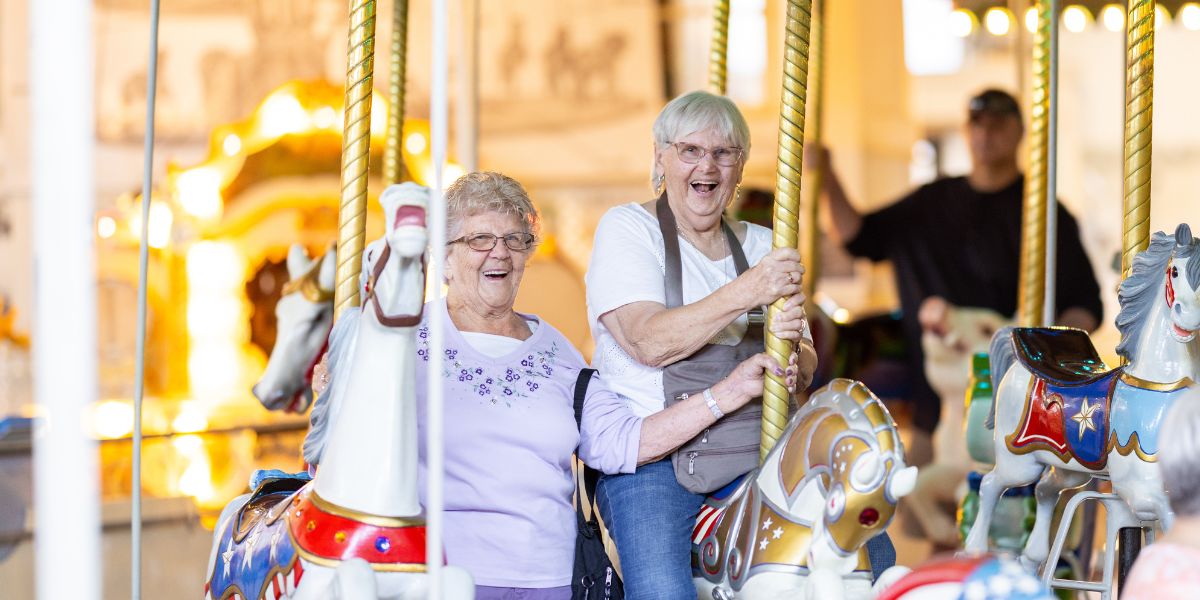 senior living residents toasting with glasses of wine while on a luxury river boat