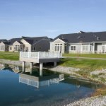 outside view of back of villa on the edge of private pond