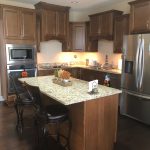 spacious modern kitchen with granite countertops and stainless steel appliances