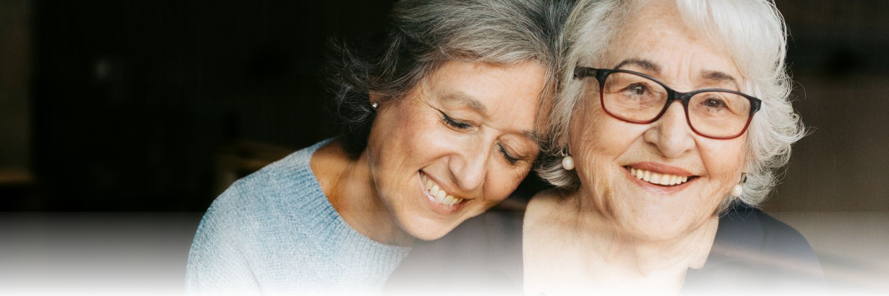 elderly woman with dementia and daughter laughing and smiling