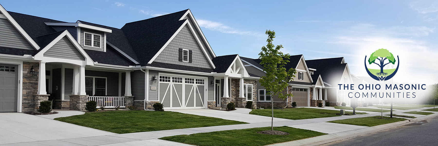 Villa living senior community pictured with blue sky, clean landscaping, and multiple new build villa houses