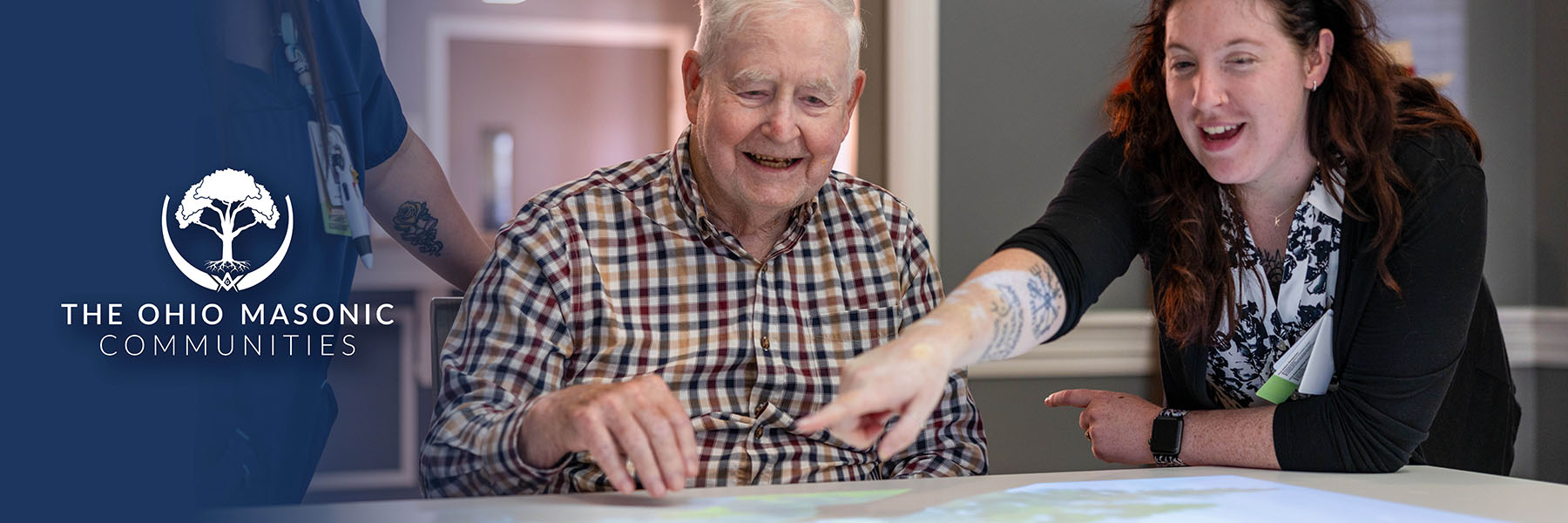 Nurse and Senior Adult use Lucynt table while laughing