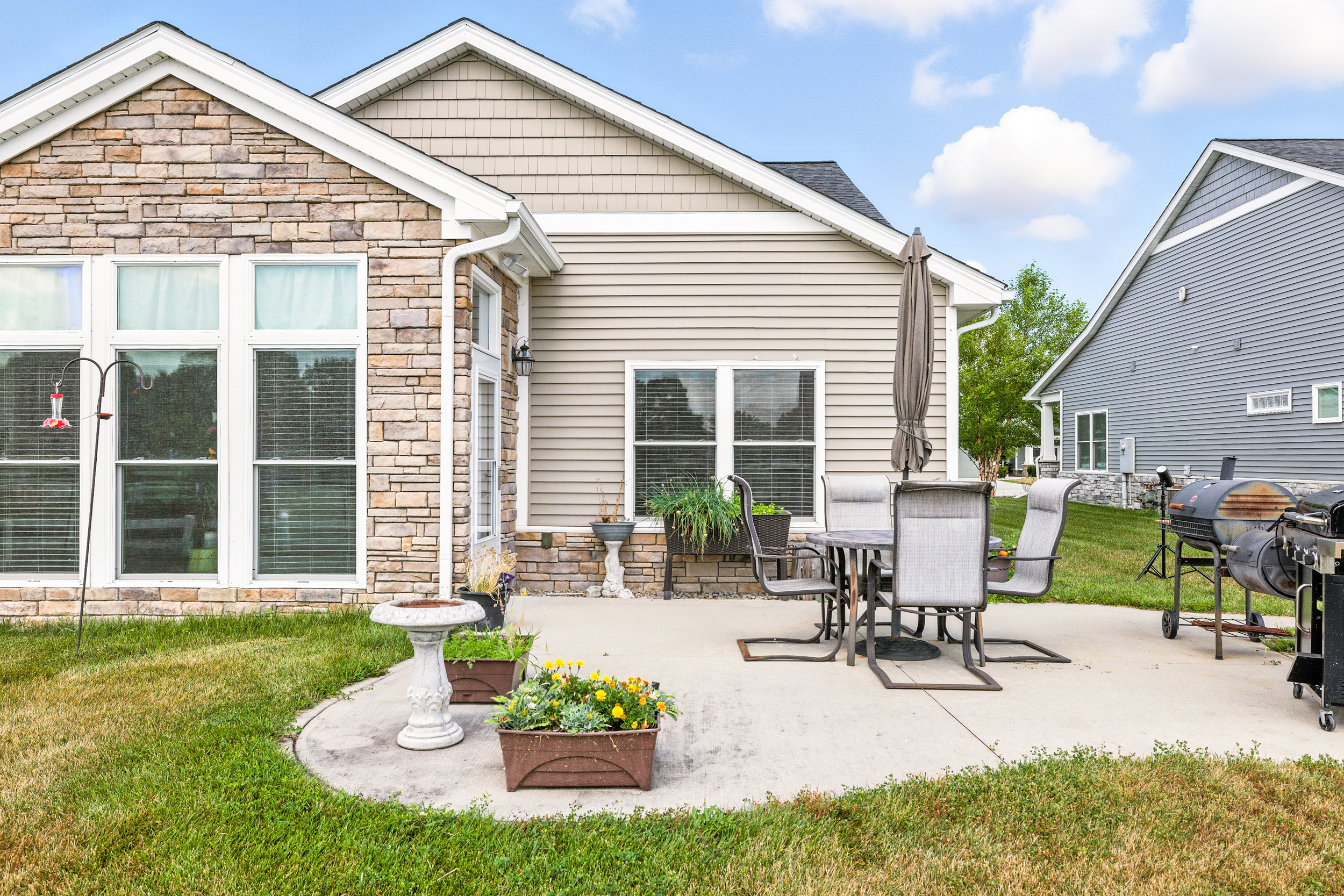 Outdoor patio with grills and table with chairs