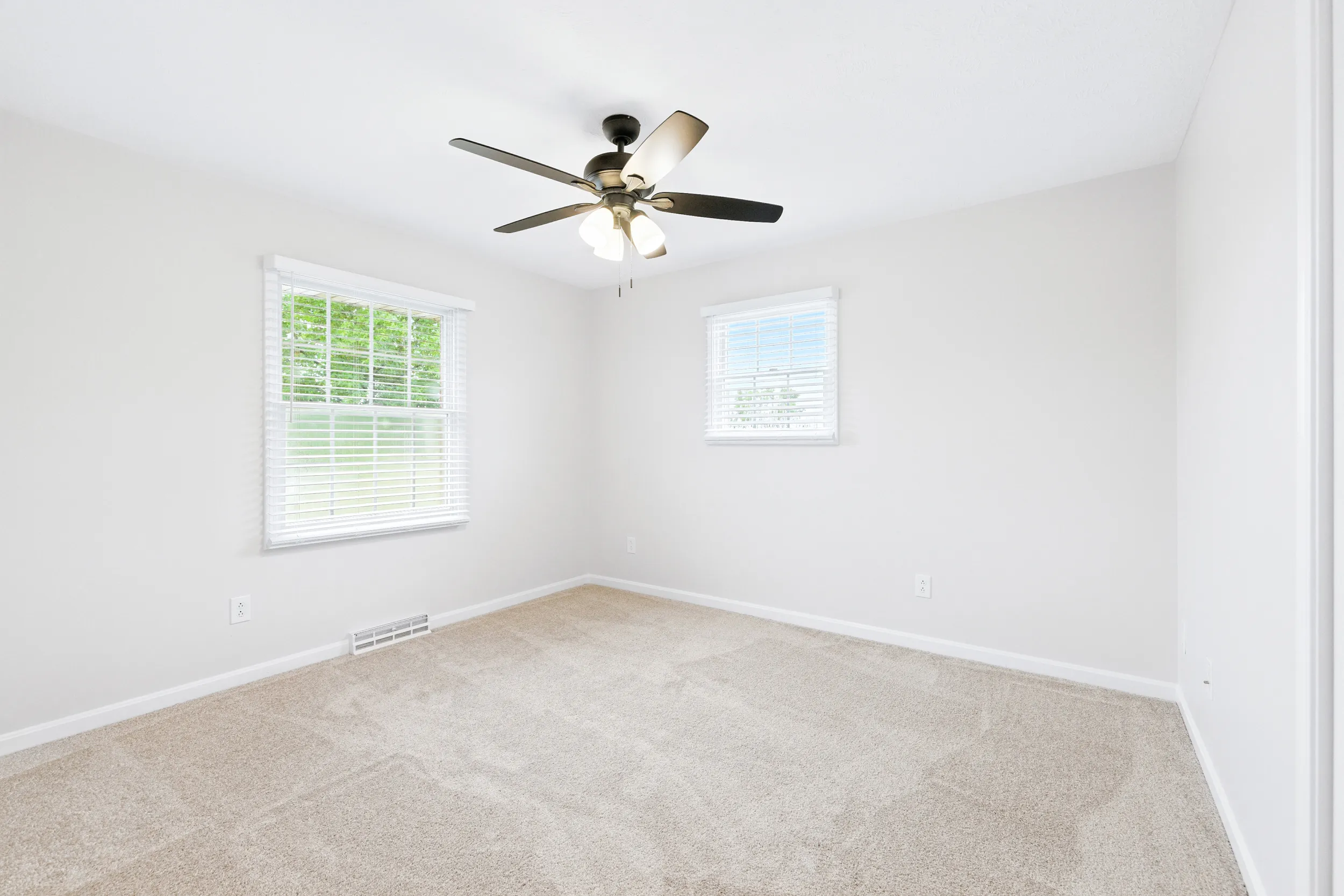 Bedroom with 2 windows and a ceiling fan