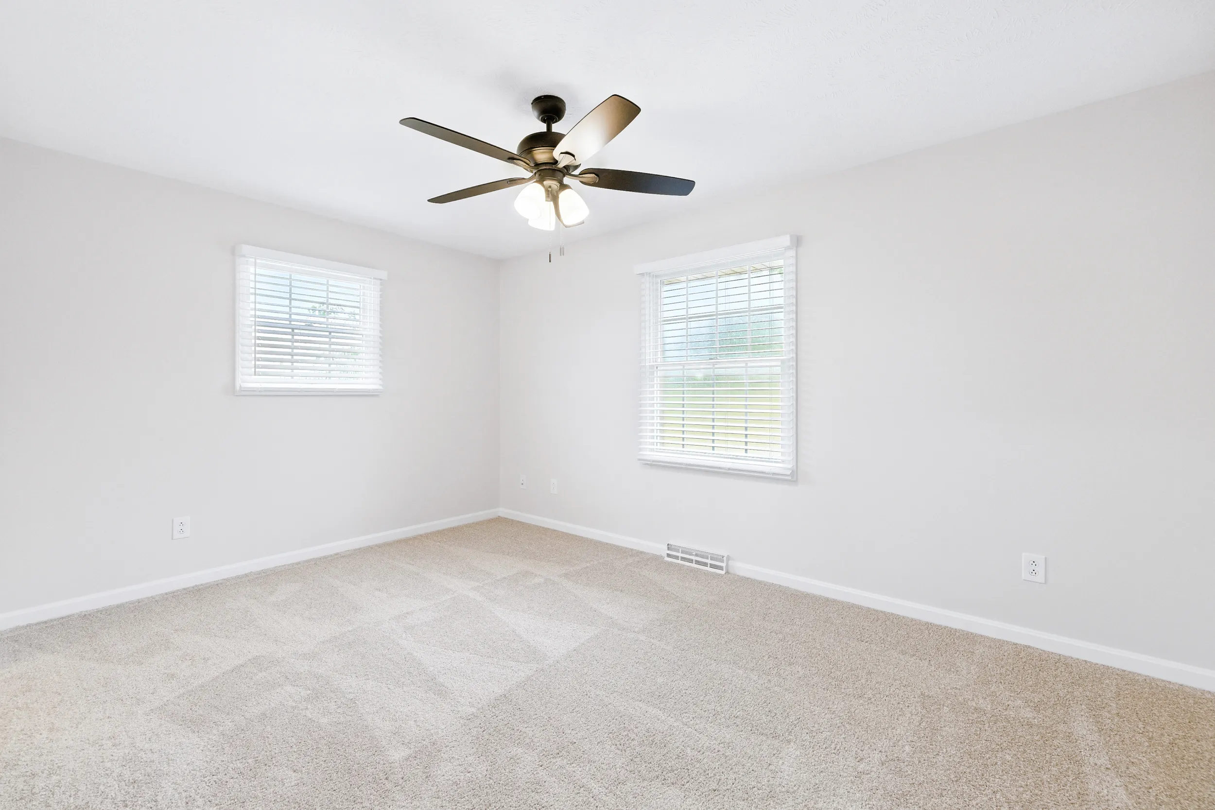 Bedroom with windows and a ceiling fan