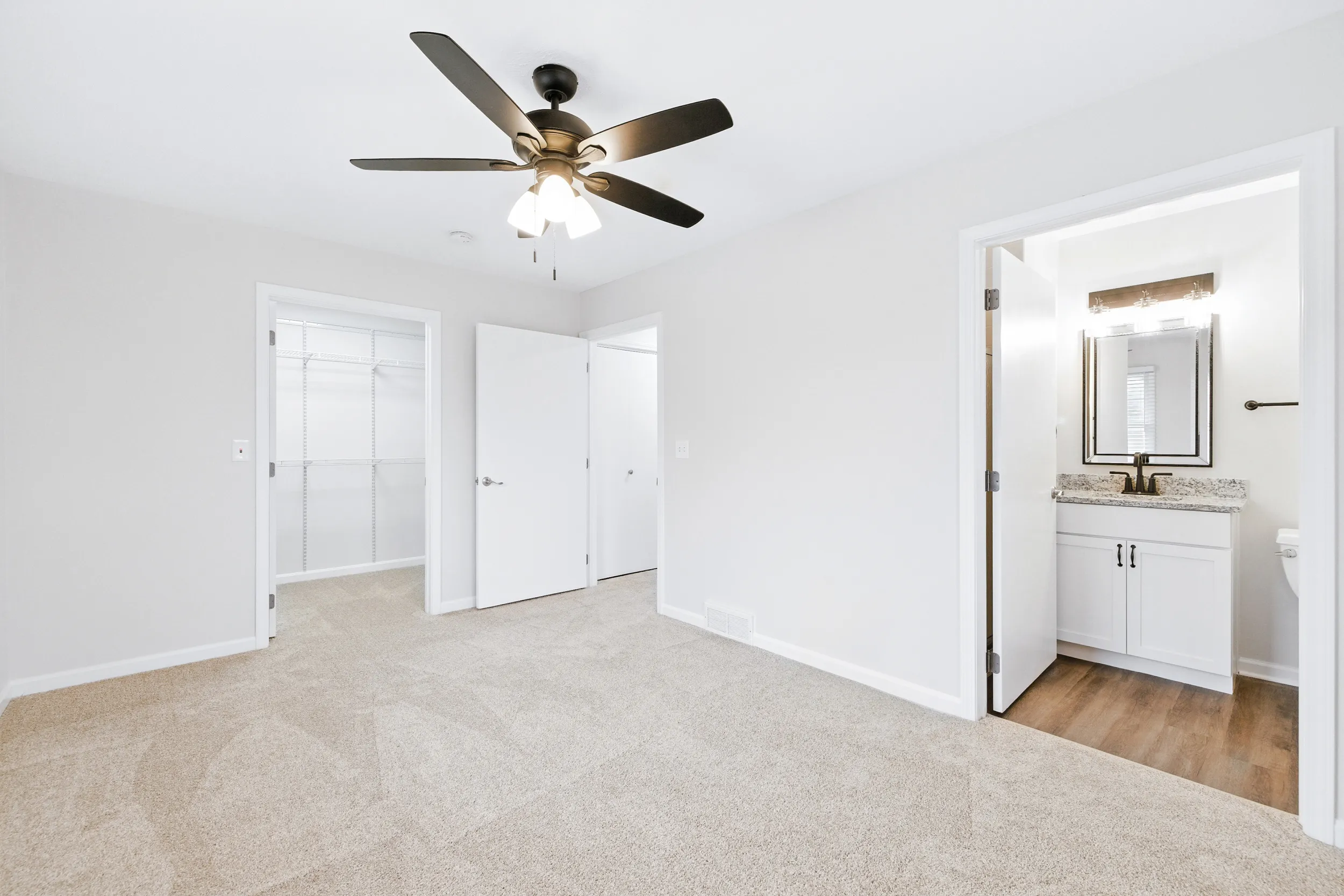 Bedroom with an attached bathroom and walk-in closet