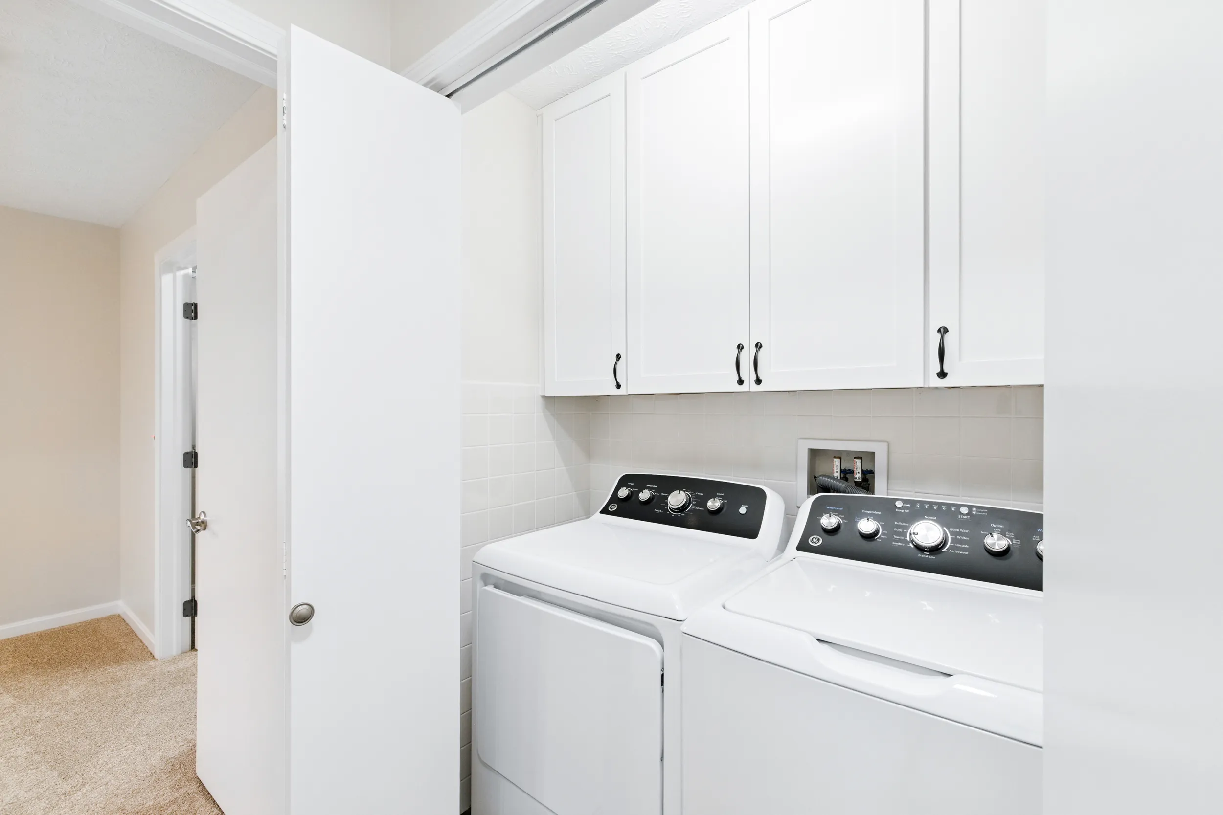 Laundry room with a washer and dryer and cabinets