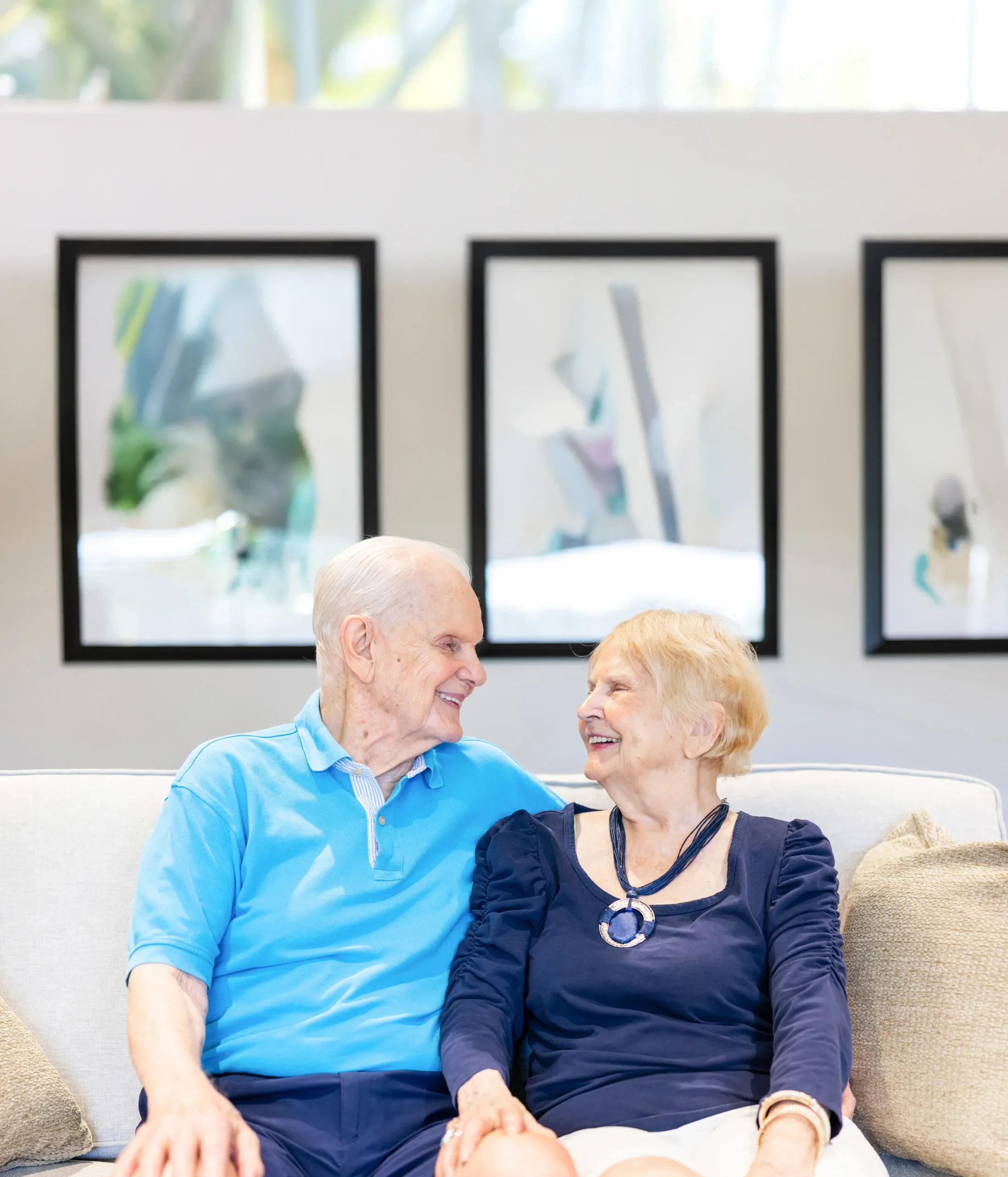 Older adult couple seated on a couch together
