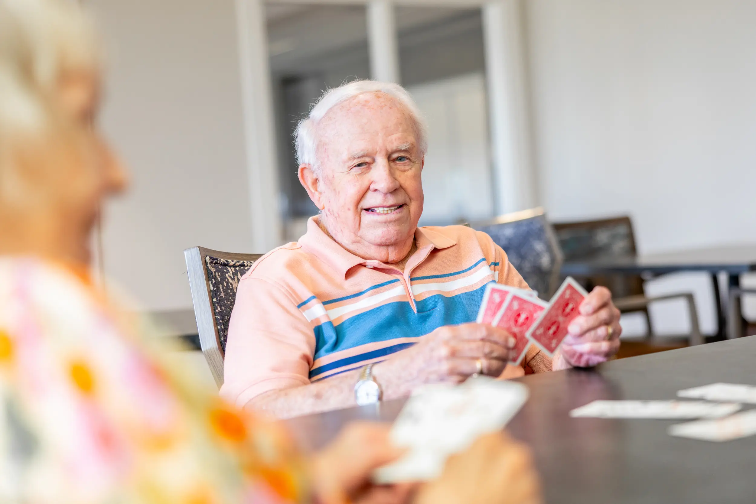 Older adult male playing cards