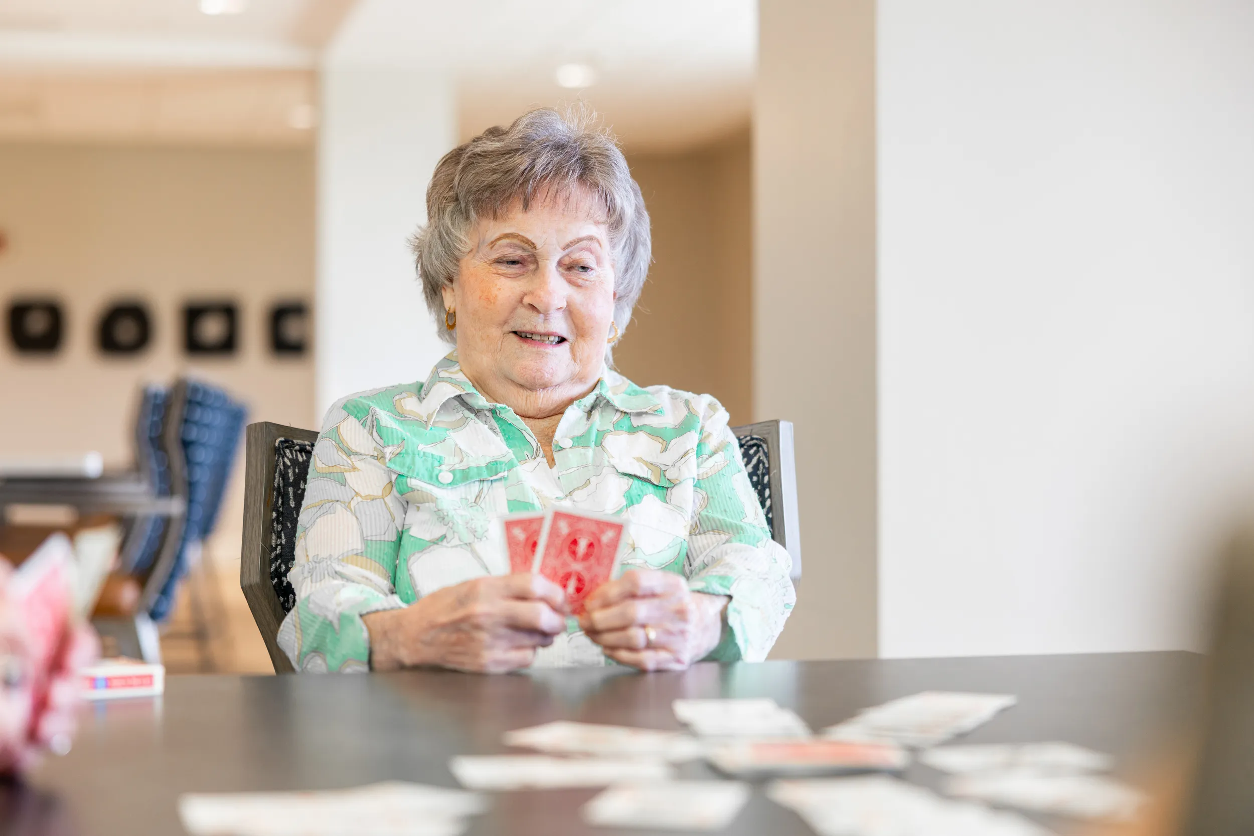 Older adult resident playing cards