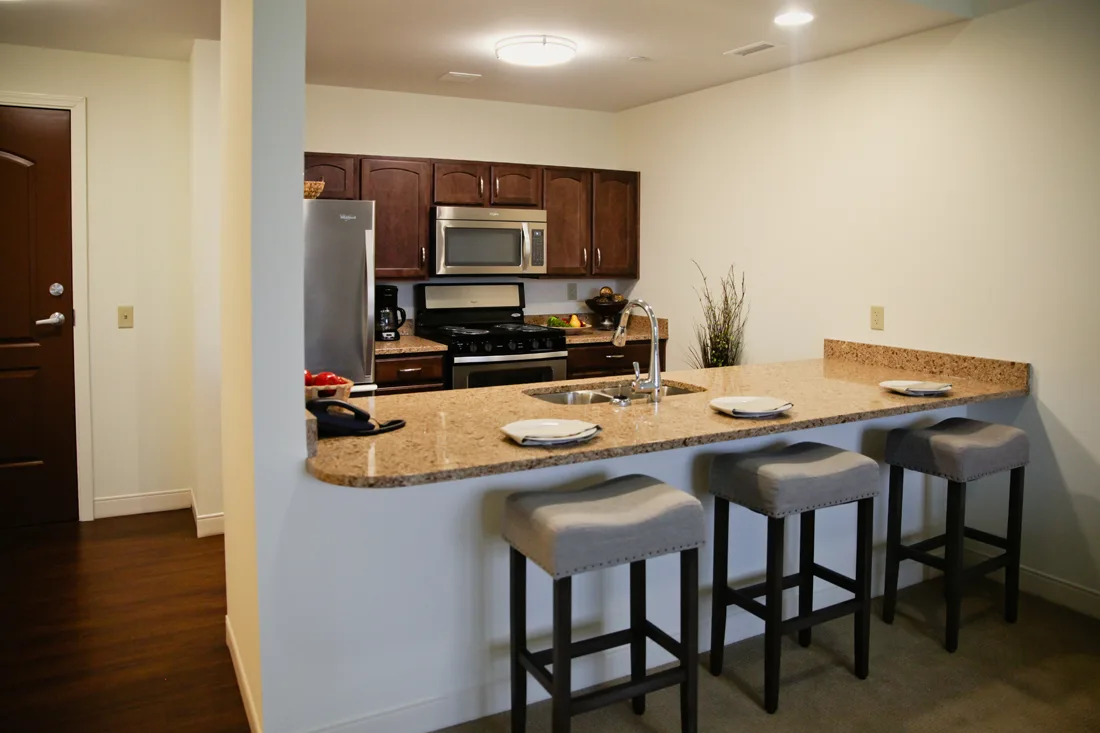 Kitchen with bar and bar stools