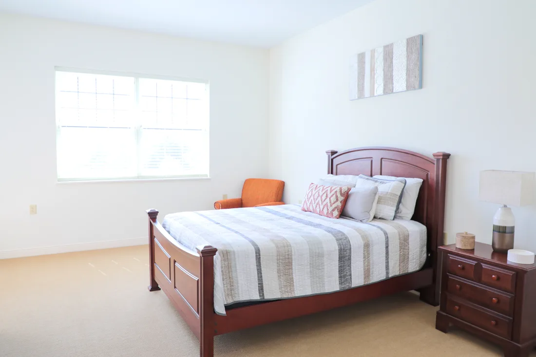 Bedroom with a large bed, chair, and nightstand