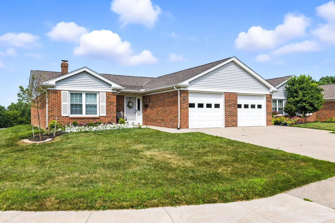 Exterior view of brick duplex villas with garages