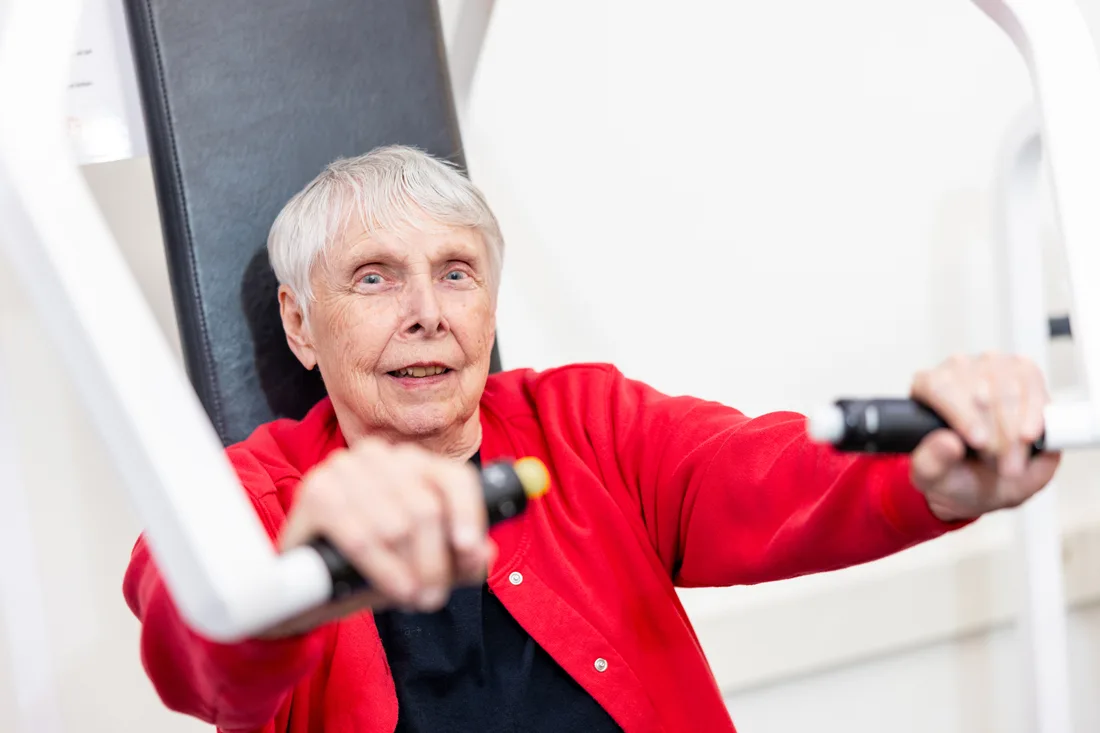 Older adult female exercises in a fitness center