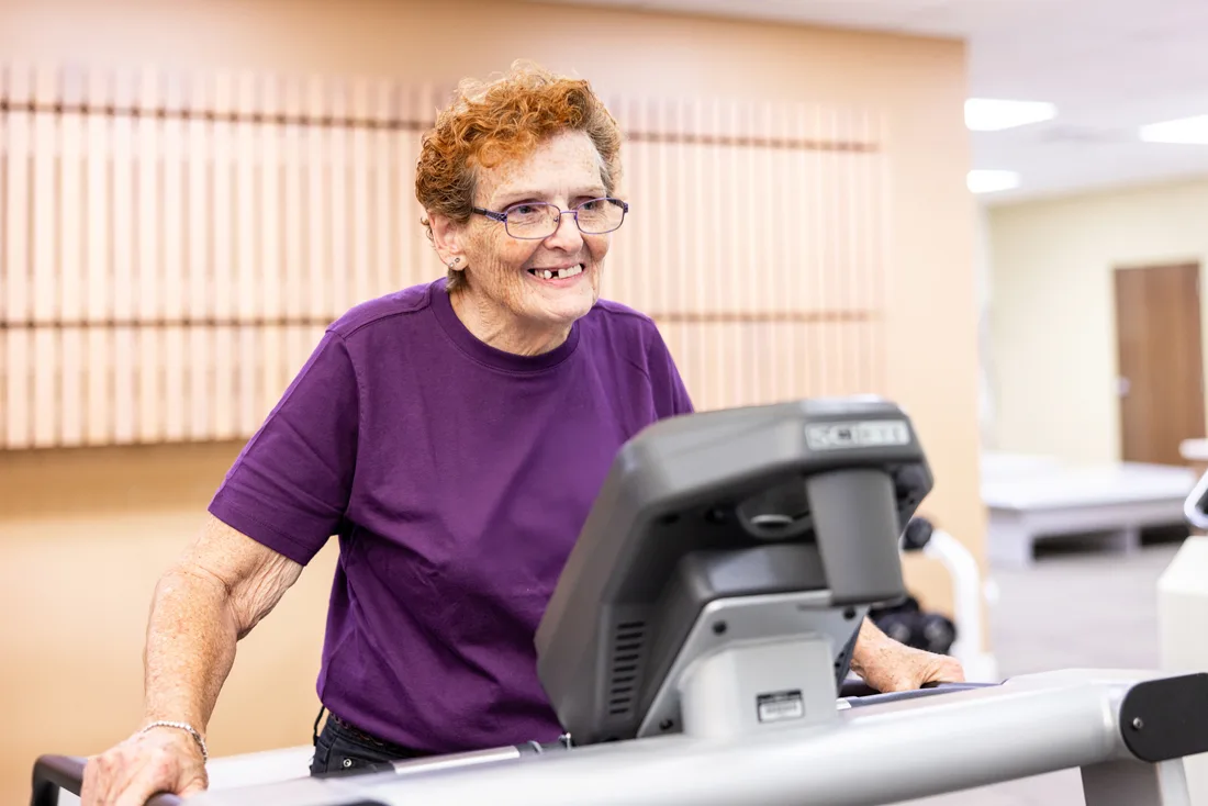 Older adult female exercises in a fitness center