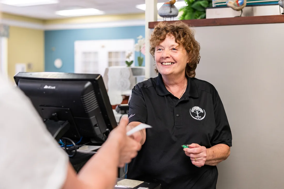 Staff member handing paper to someone