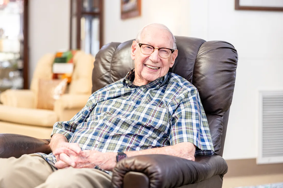 Older adult male sitting in a chair