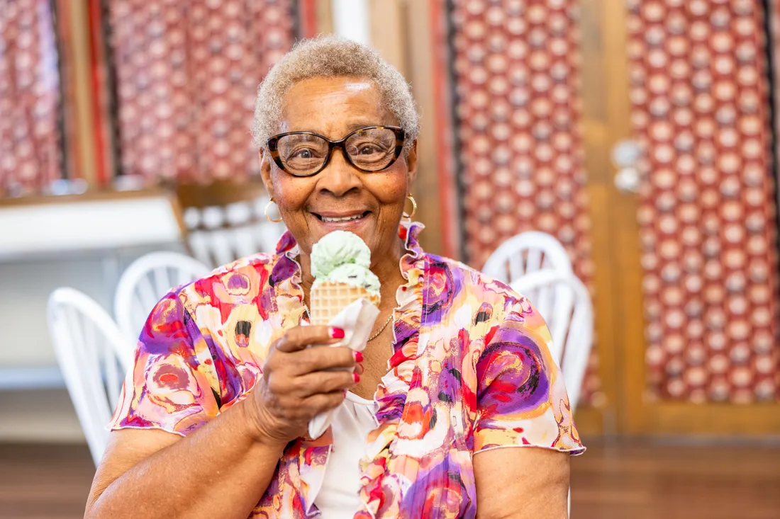 Older adult female eating an ice cream cone