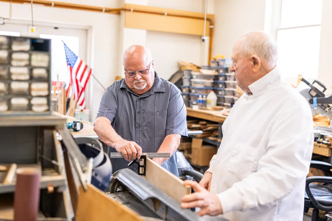 Older adult men working in a woodshop
