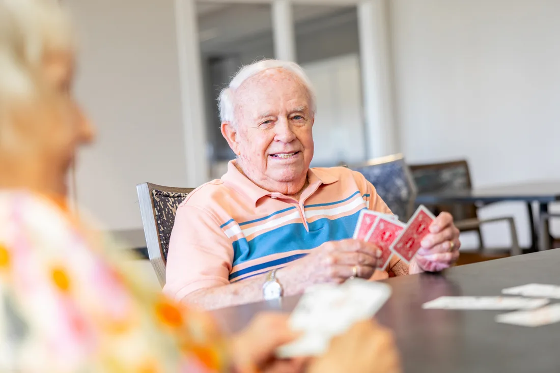 Older adult male playing cards