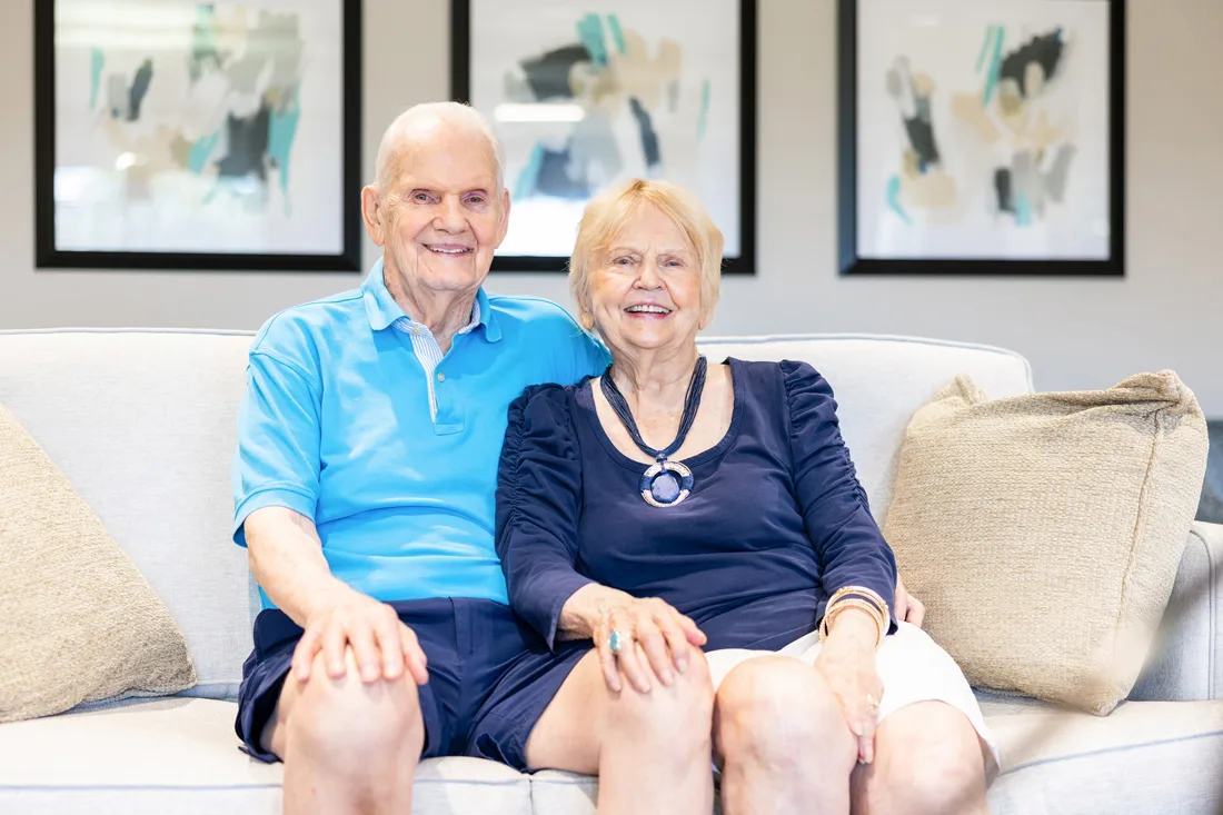Older adult couple sitting on a couch