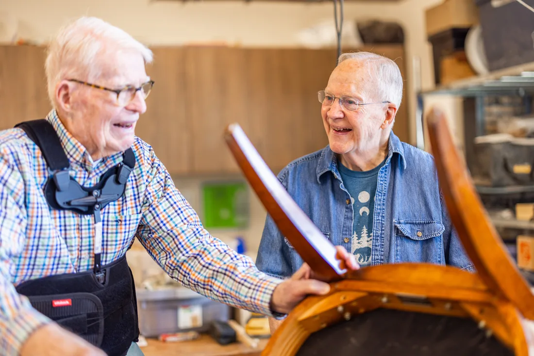 Older adult men work in the woodshop