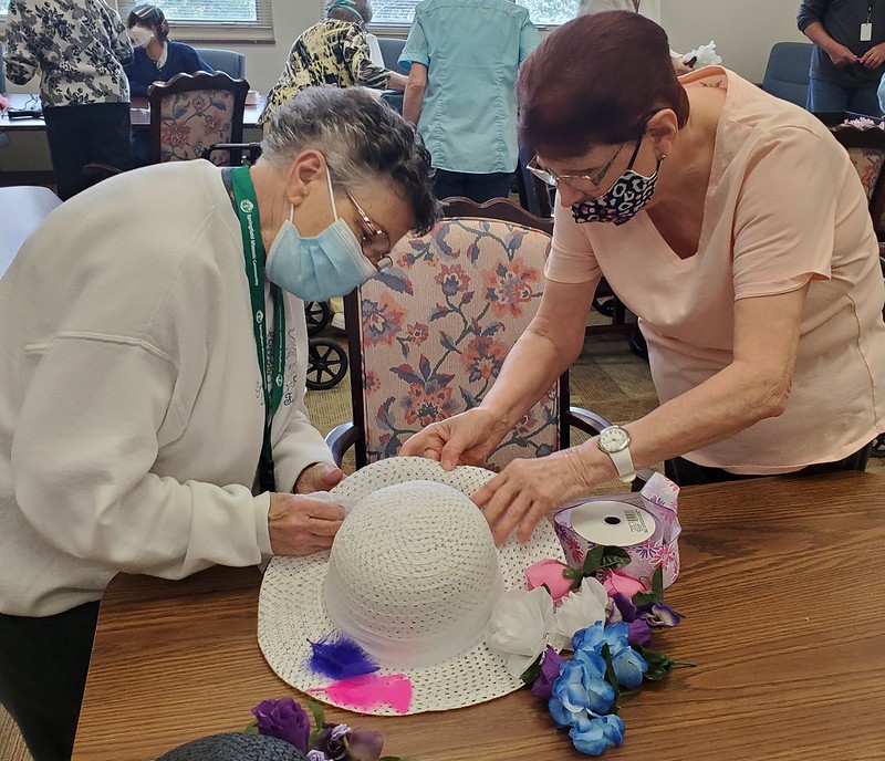 Resident decorating hats at a Derby Day event
