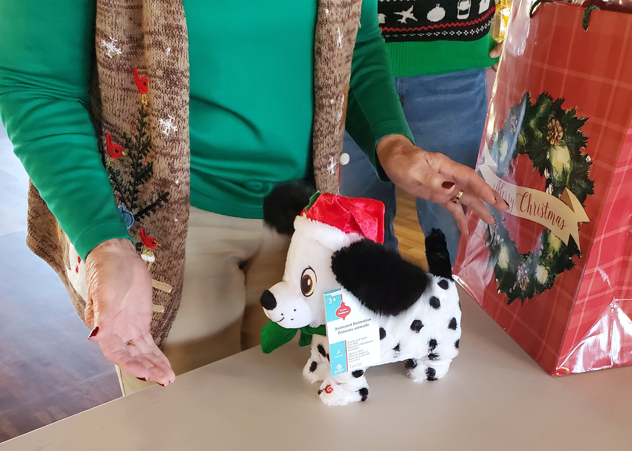 Residents stand by a plush Dalmation toy near a gift bag