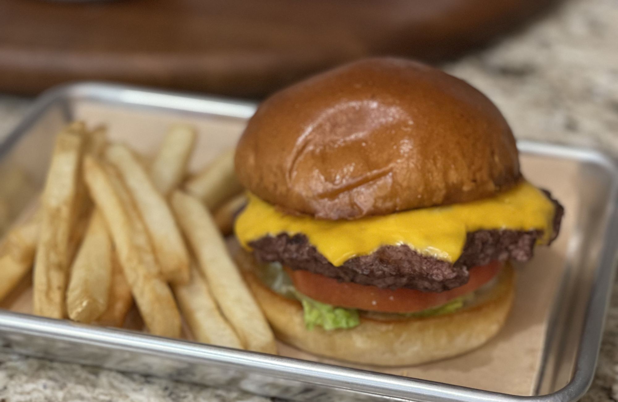 Close-up view of cheeseburger and fries