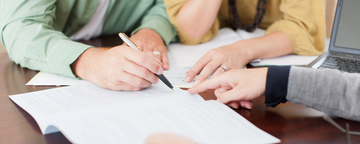 Individuals reviewing documents together