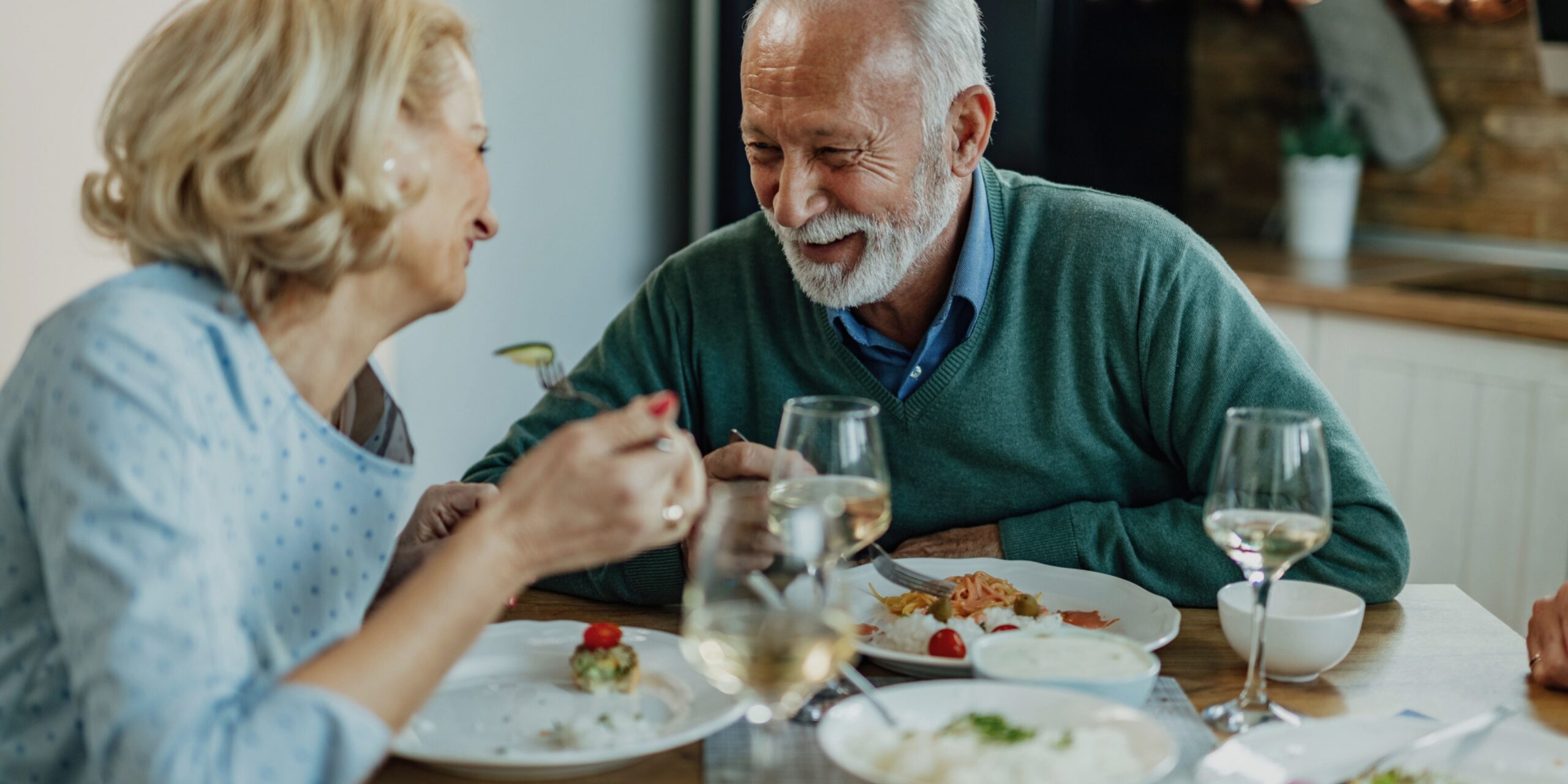 Male and female older adult couple dine together