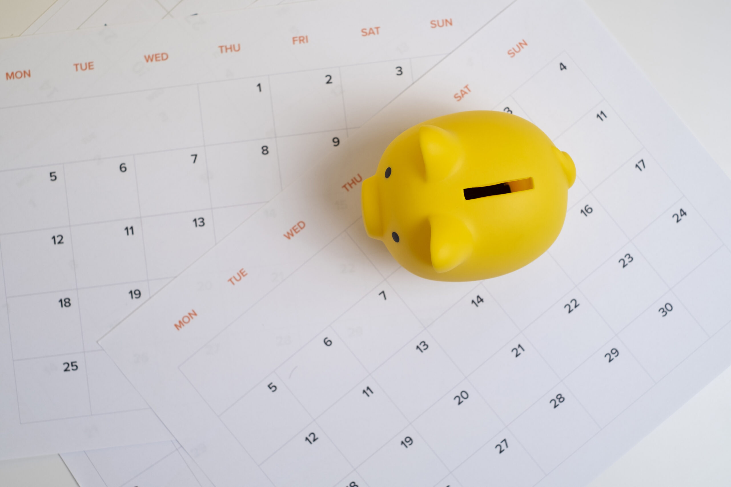 Calendar and yellow piggy bank