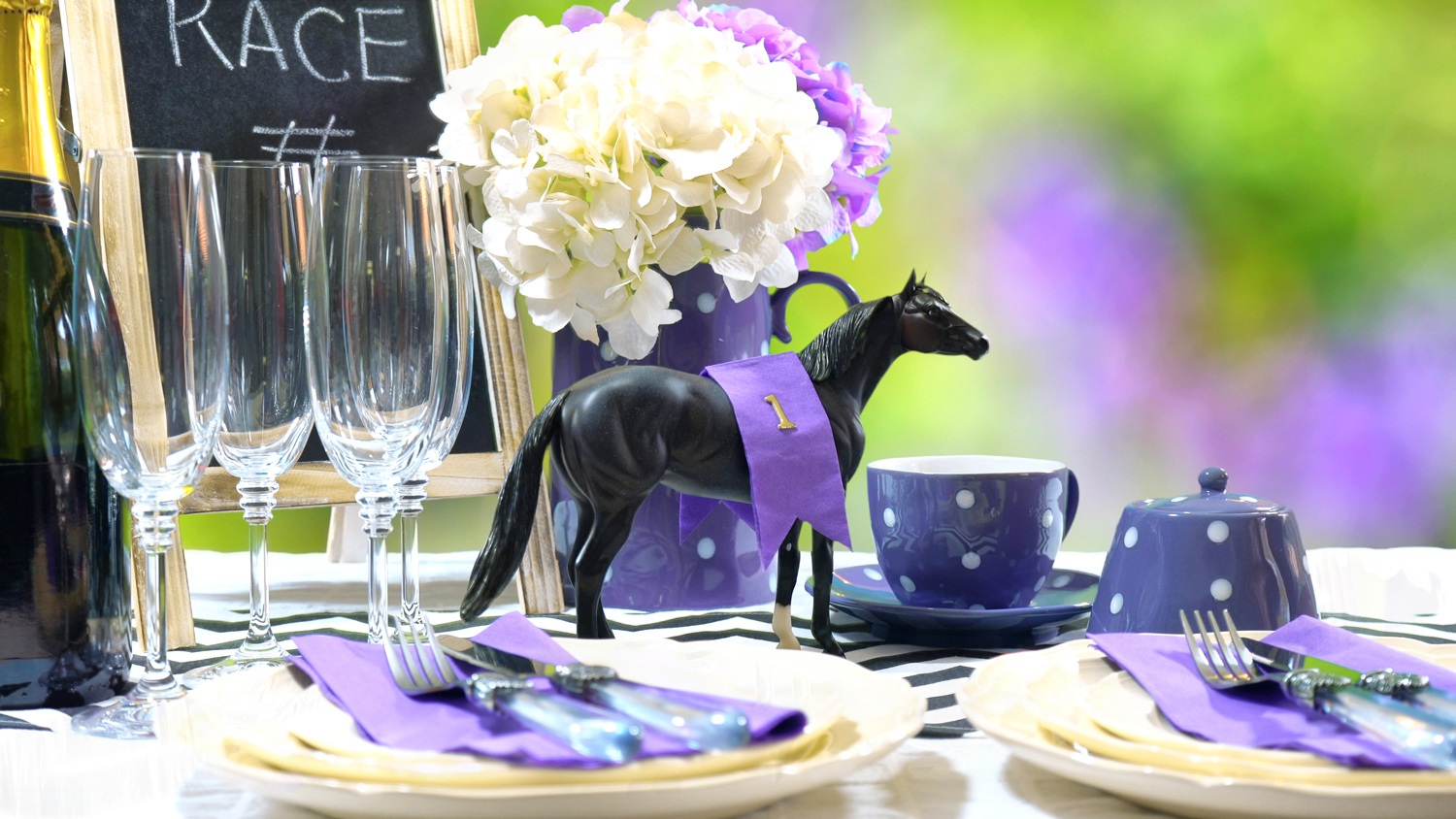Close up view of plastic horse table decoration with fresh flowers and place settings