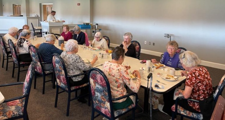 Residents and staff dining at the Ladies Breakfast event