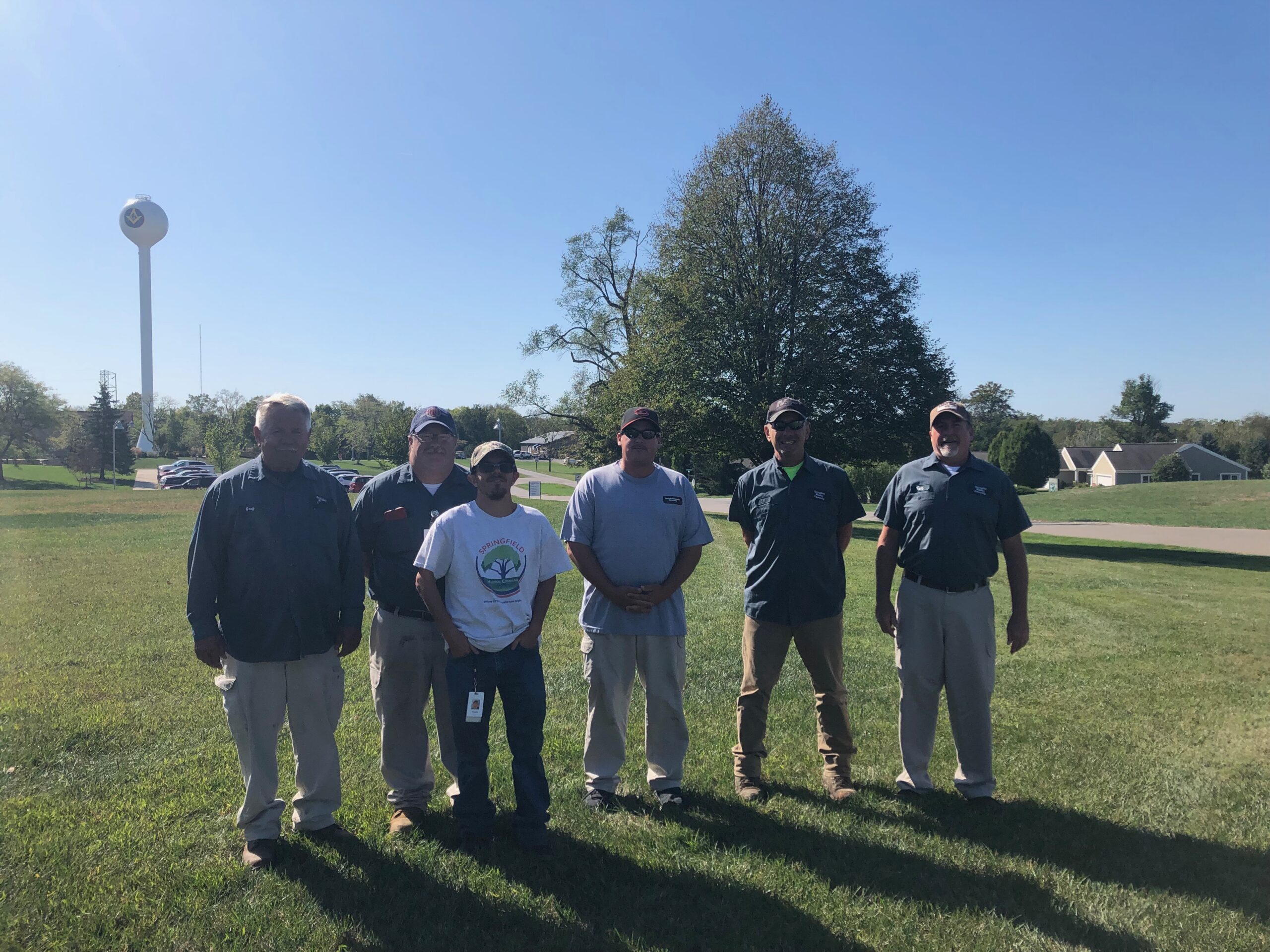 Team members stand together outside
