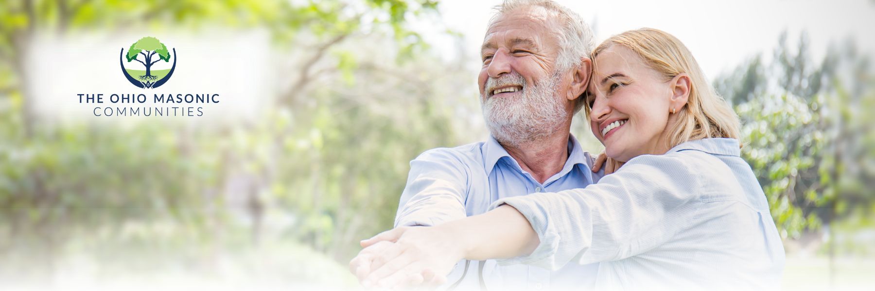 Older adult couple embraces and holds hands outdoors