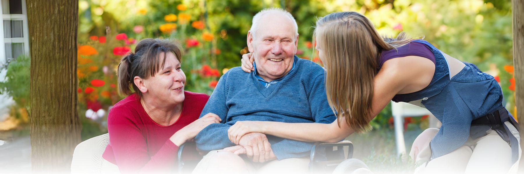 senior adult man in a wheelchair surrounded by family and caregivers