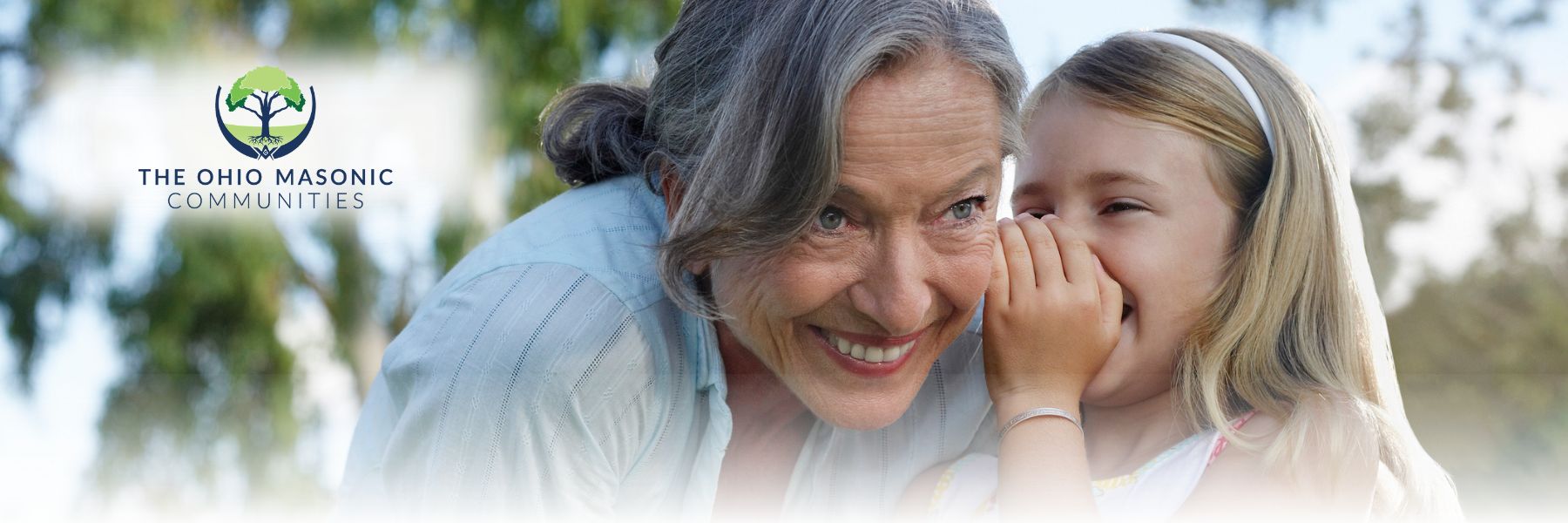 Young child shares a secret with an older adult female