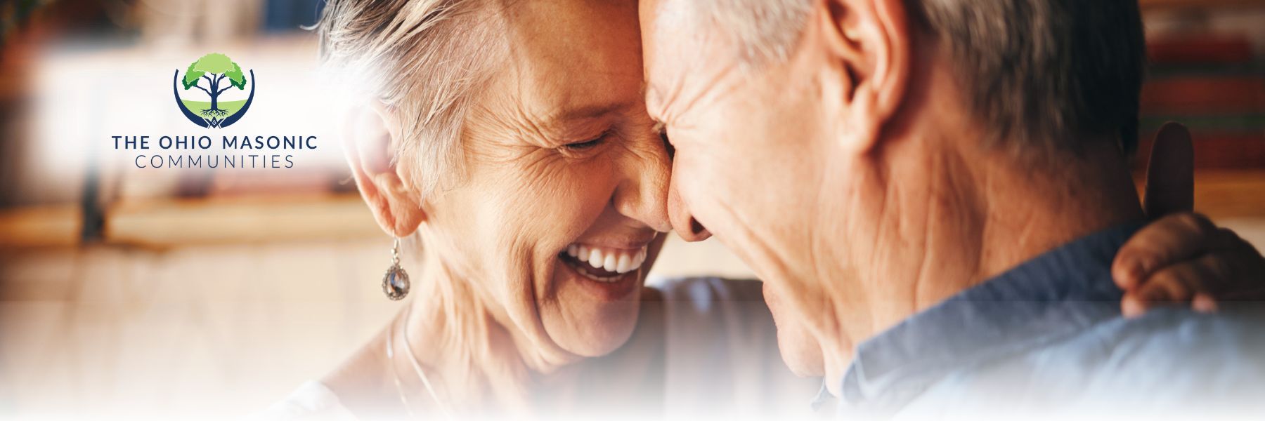 Older adult couple smile and place their foreheads together