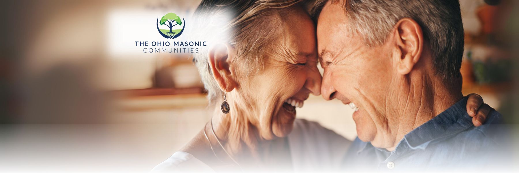 Older adult couple smile and touch their noses and foreheads together