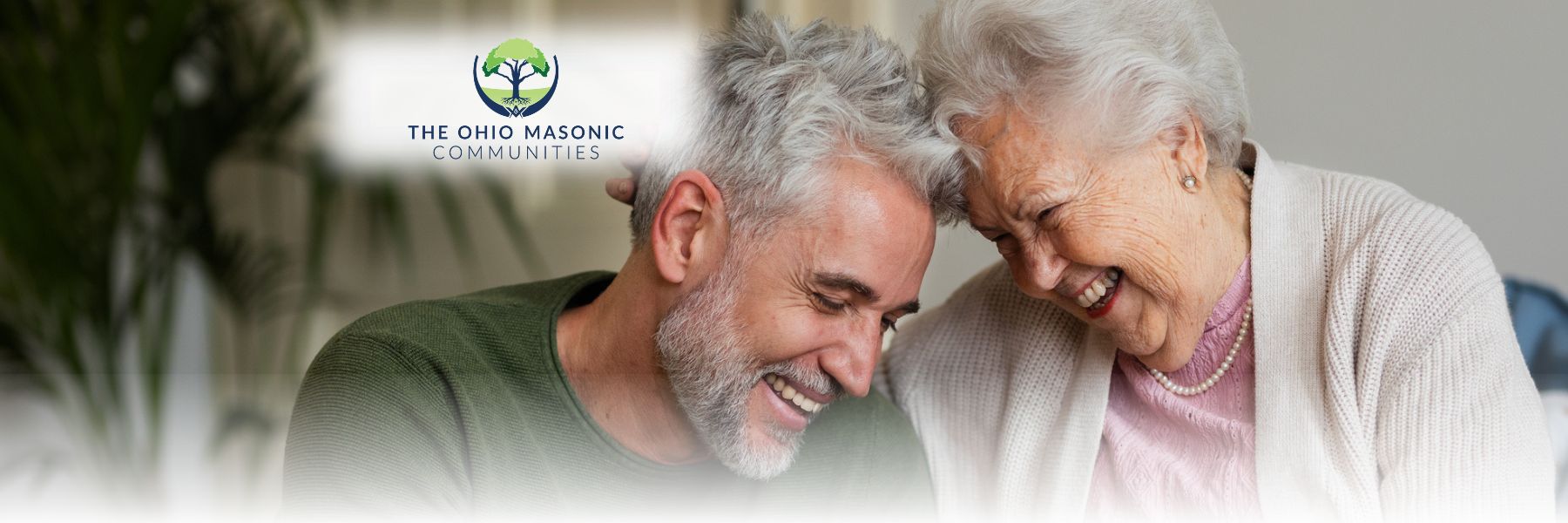 Older adult male and female touch their foreheads together and smile