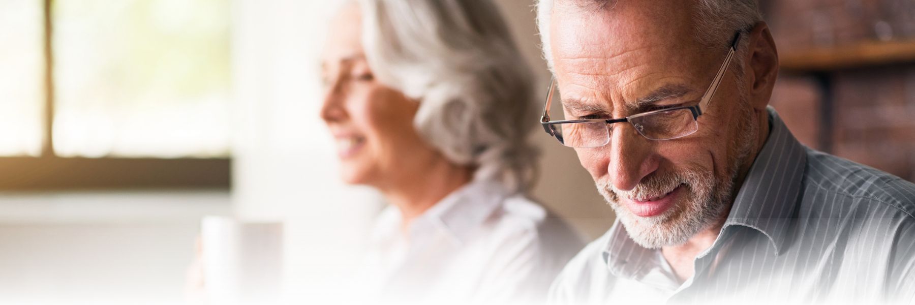 Older adult man sitting with older adult woman
