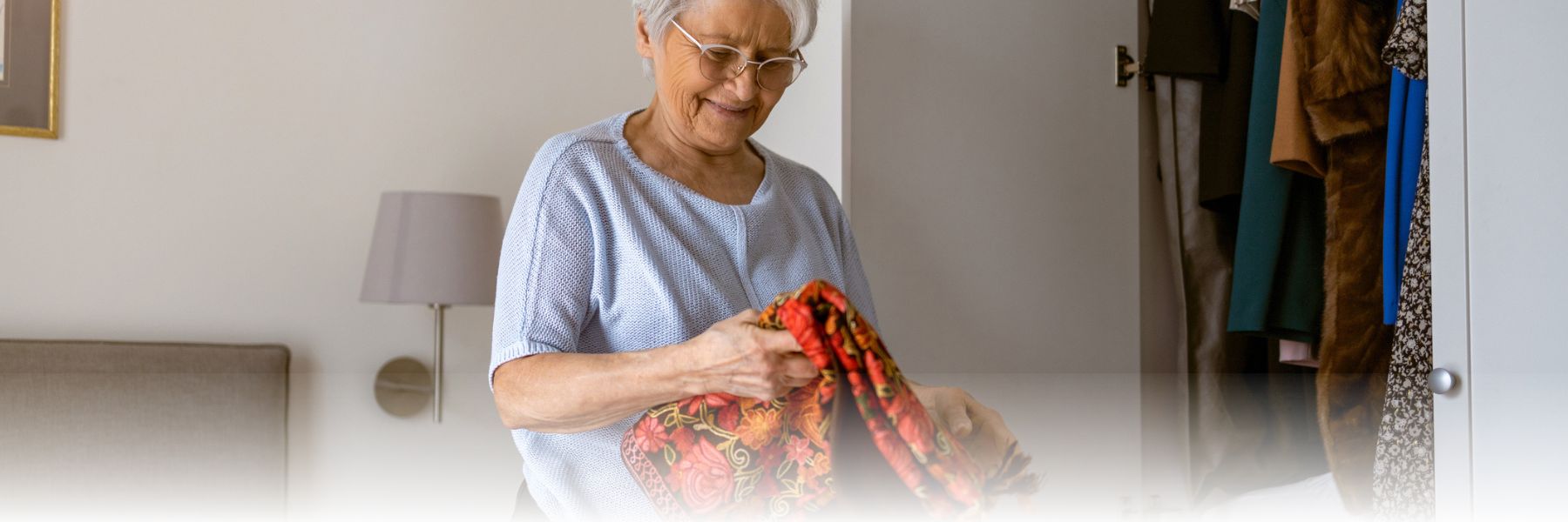 Older adult women packing and preparing for her move to a retirement community