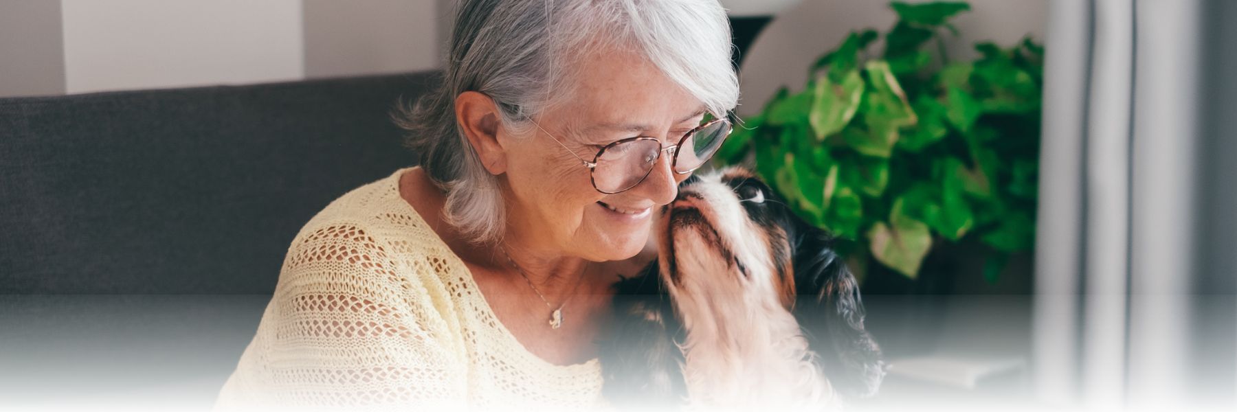 Older adult women checking for pet-friendly retirement communities with her dog
