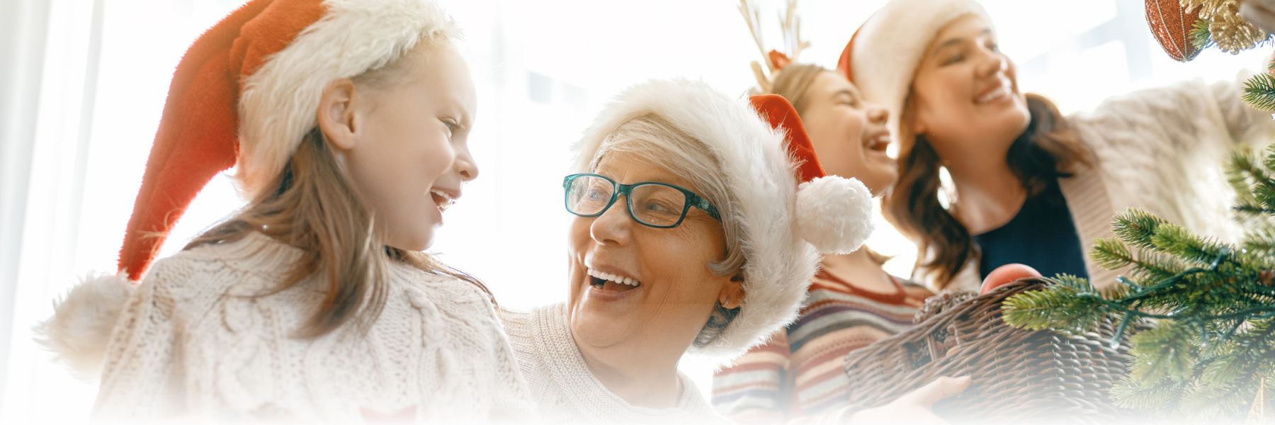 Multi-generational females decorate the tree for the holidays