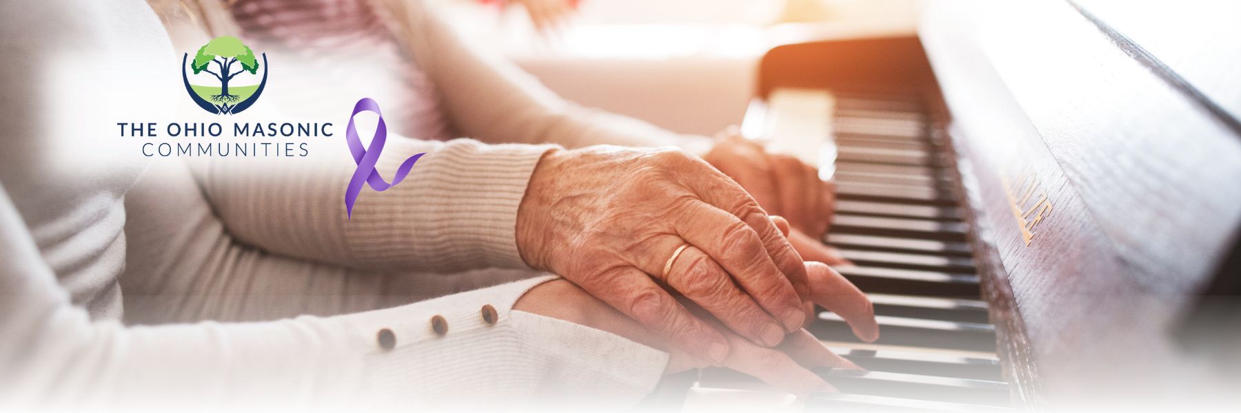 Older adult and adult play the piano together