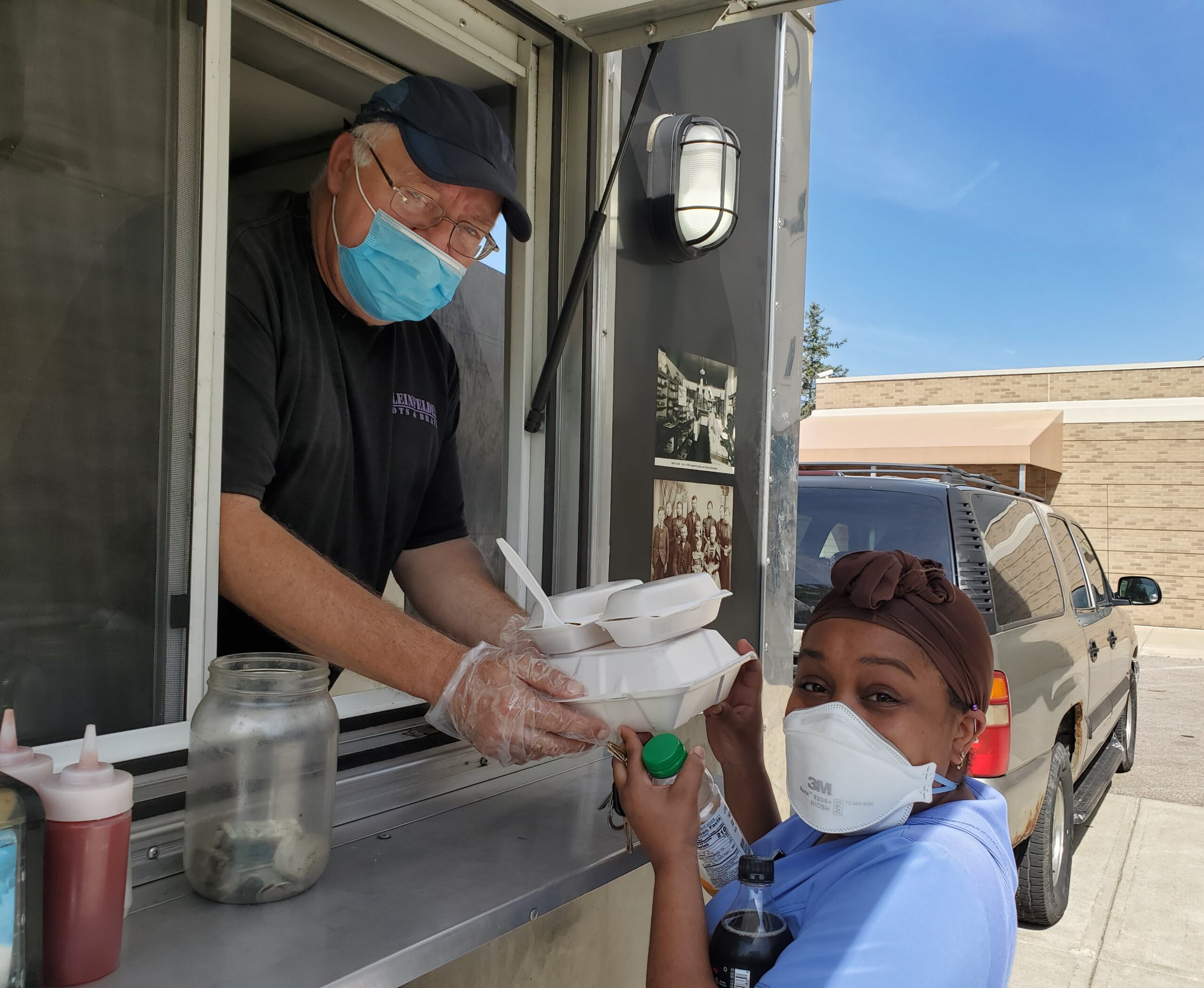 Team member picks up order at food truck
