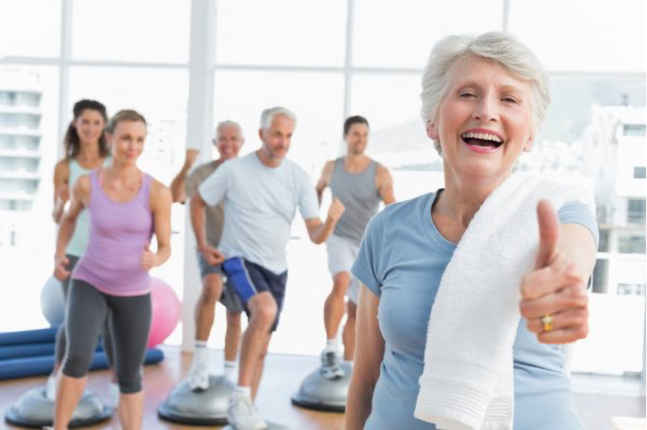 Seniors and adults exercise indoors together