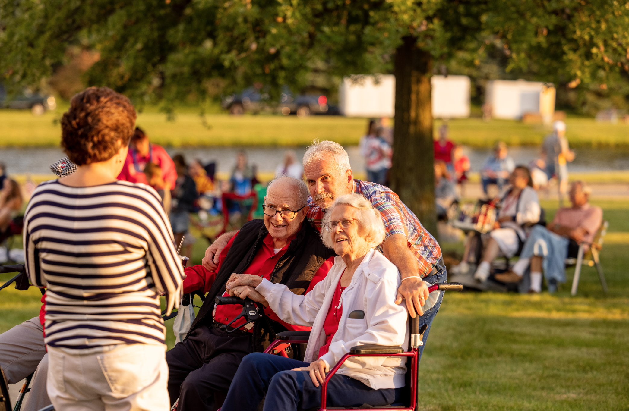 Large crowd seated outside watching a program on the 4th of July
