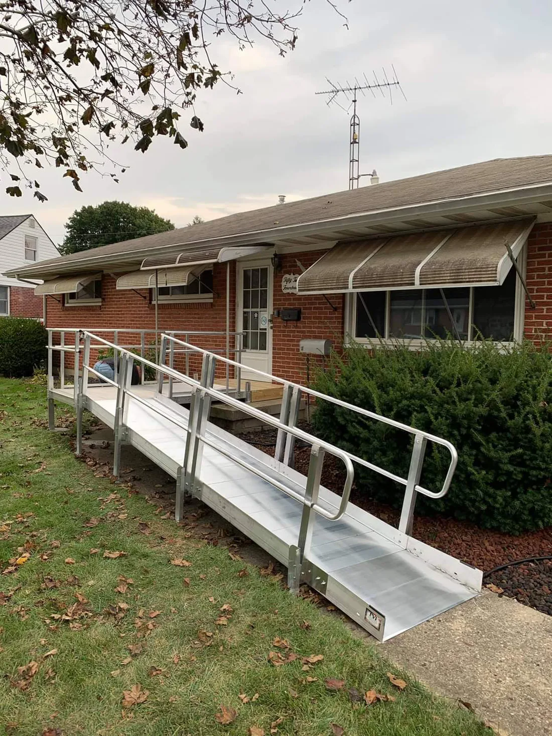 Exterior view of a house with a wheelchair ramp leading to the front door